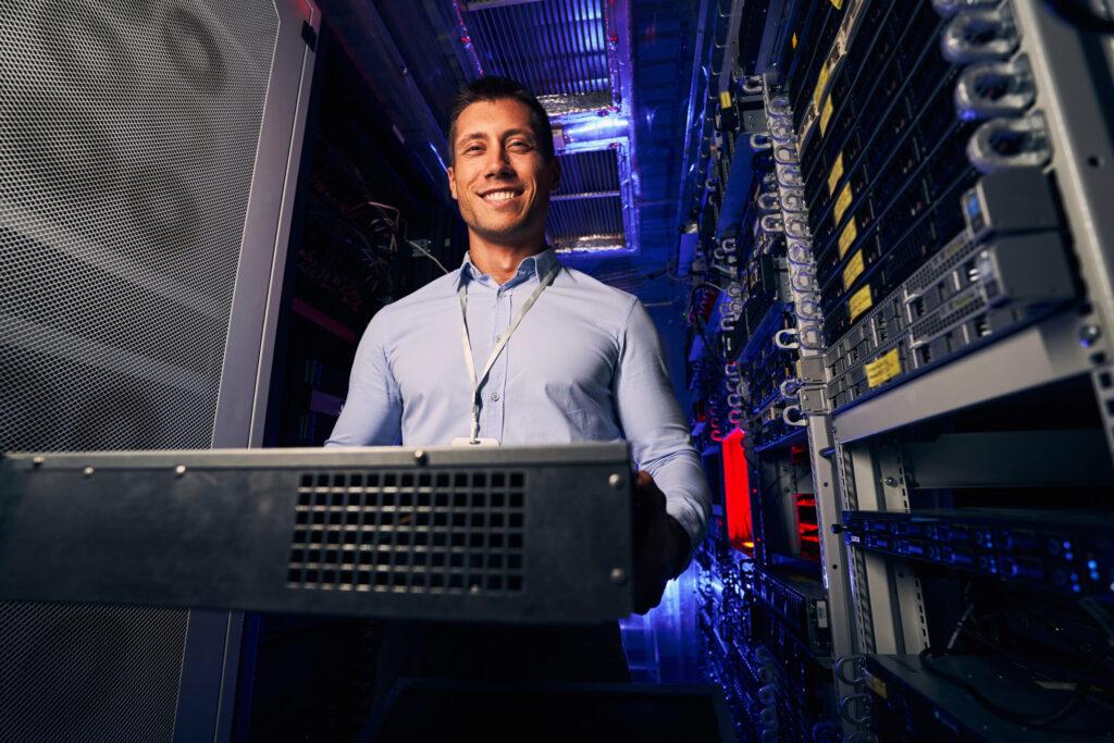 Smiling pleased engineer demonstrating new hardware component